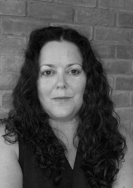 A woman smiles at the camera.