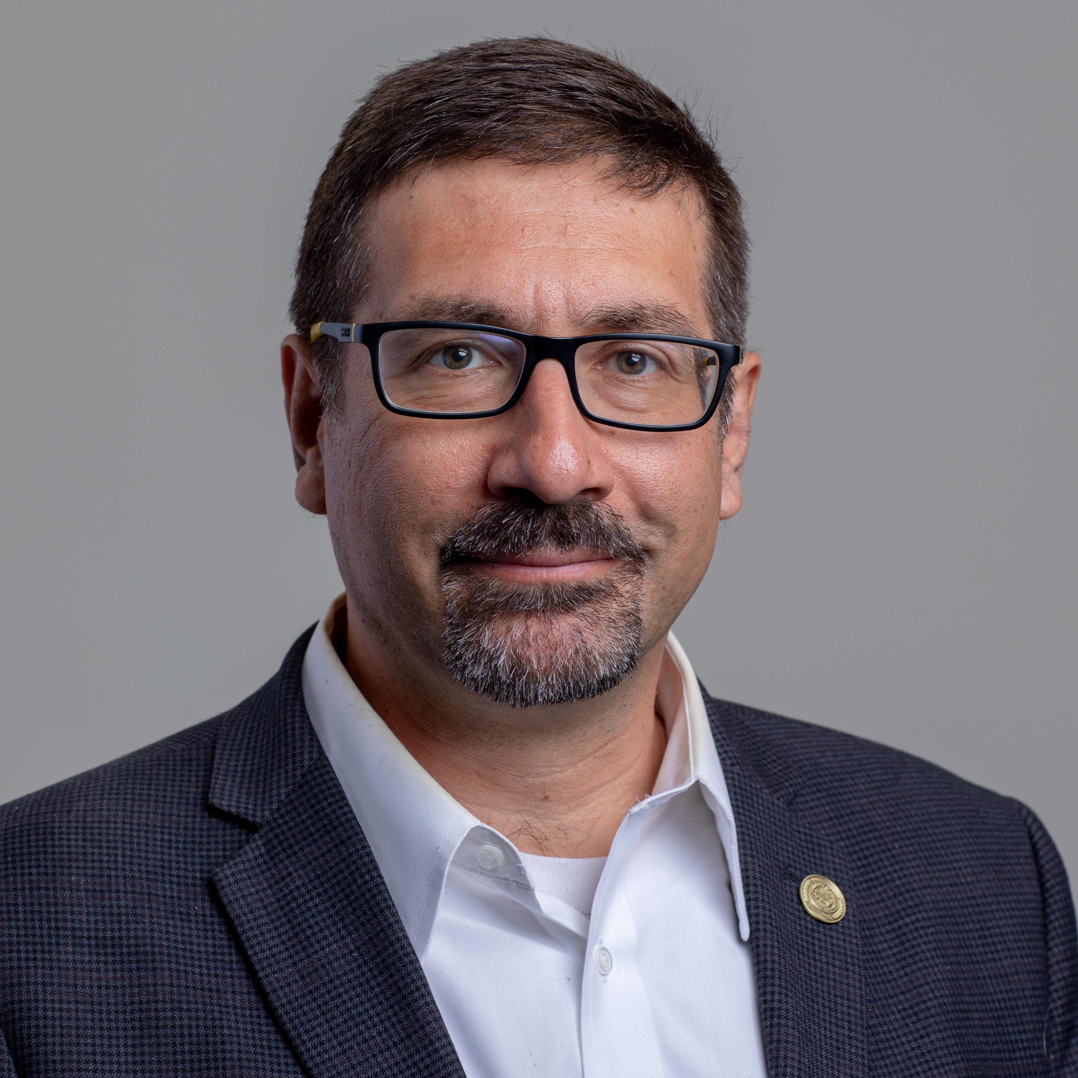 Close-up of a man smiling at the camera.