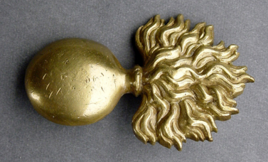 Gold-colored badge showing an exploding bomb.