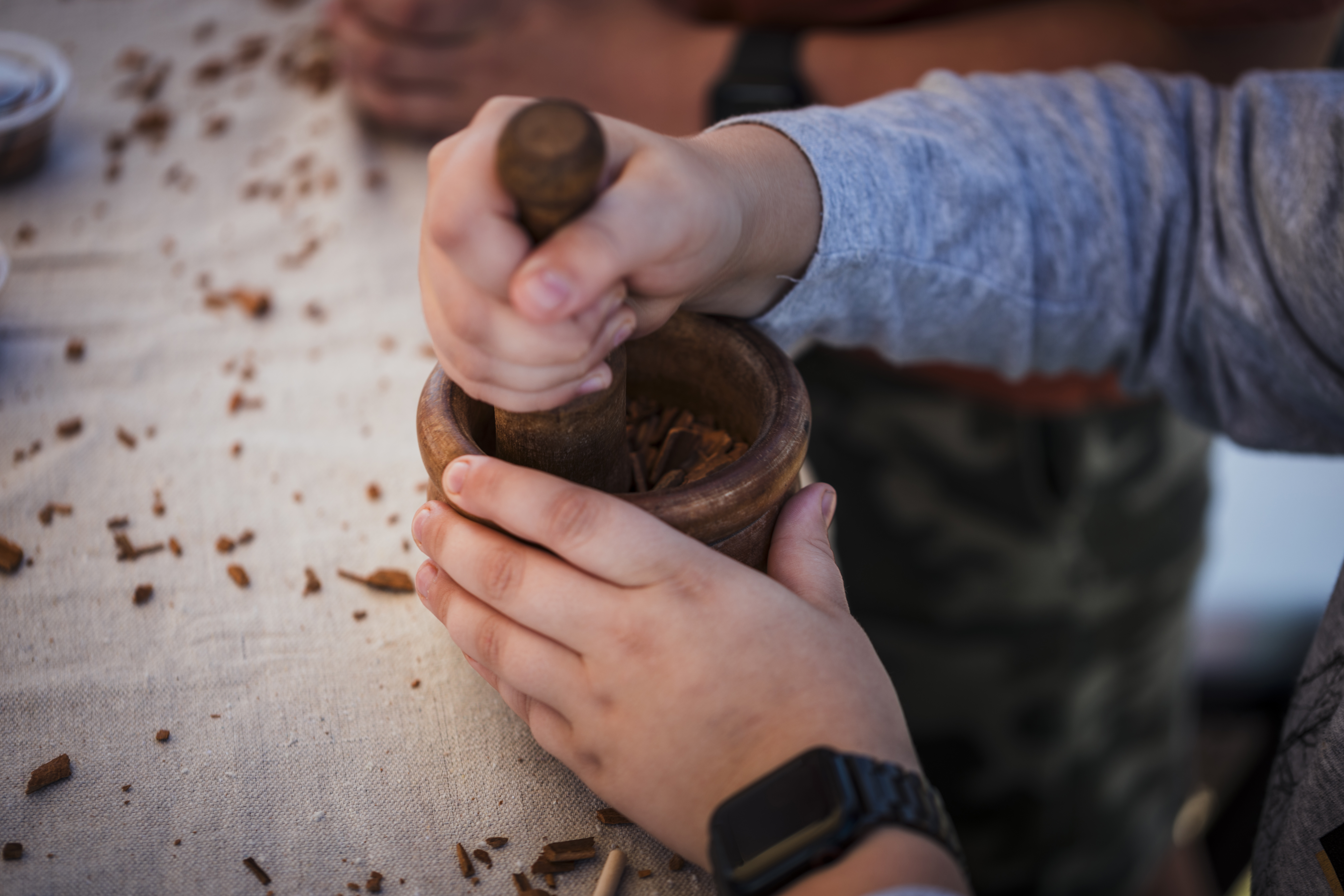 Hands use a mortar and pestle.