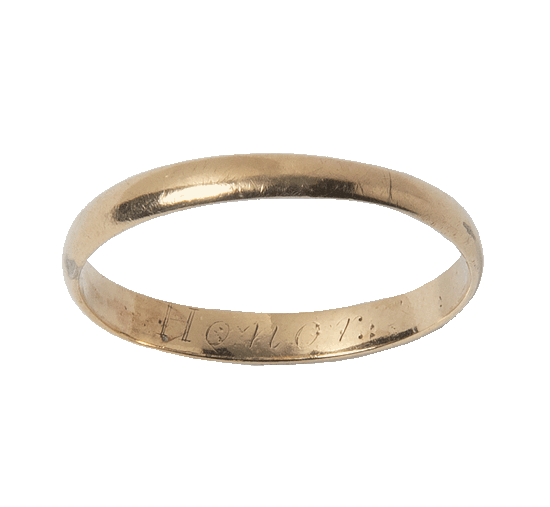 A slim gold ring engraved with the word "honor" on the inside.